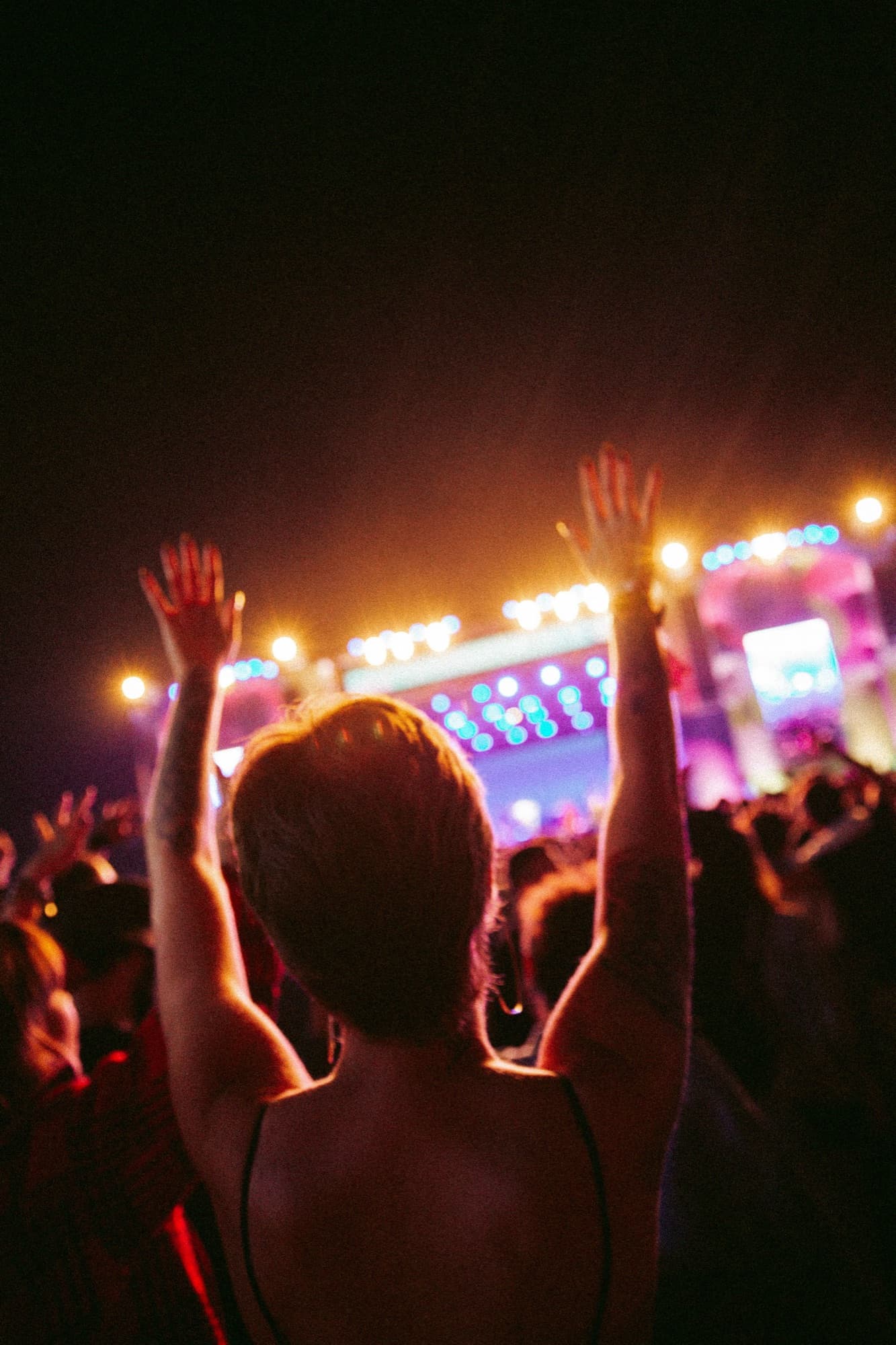 Festival crowd at night in front of the stage