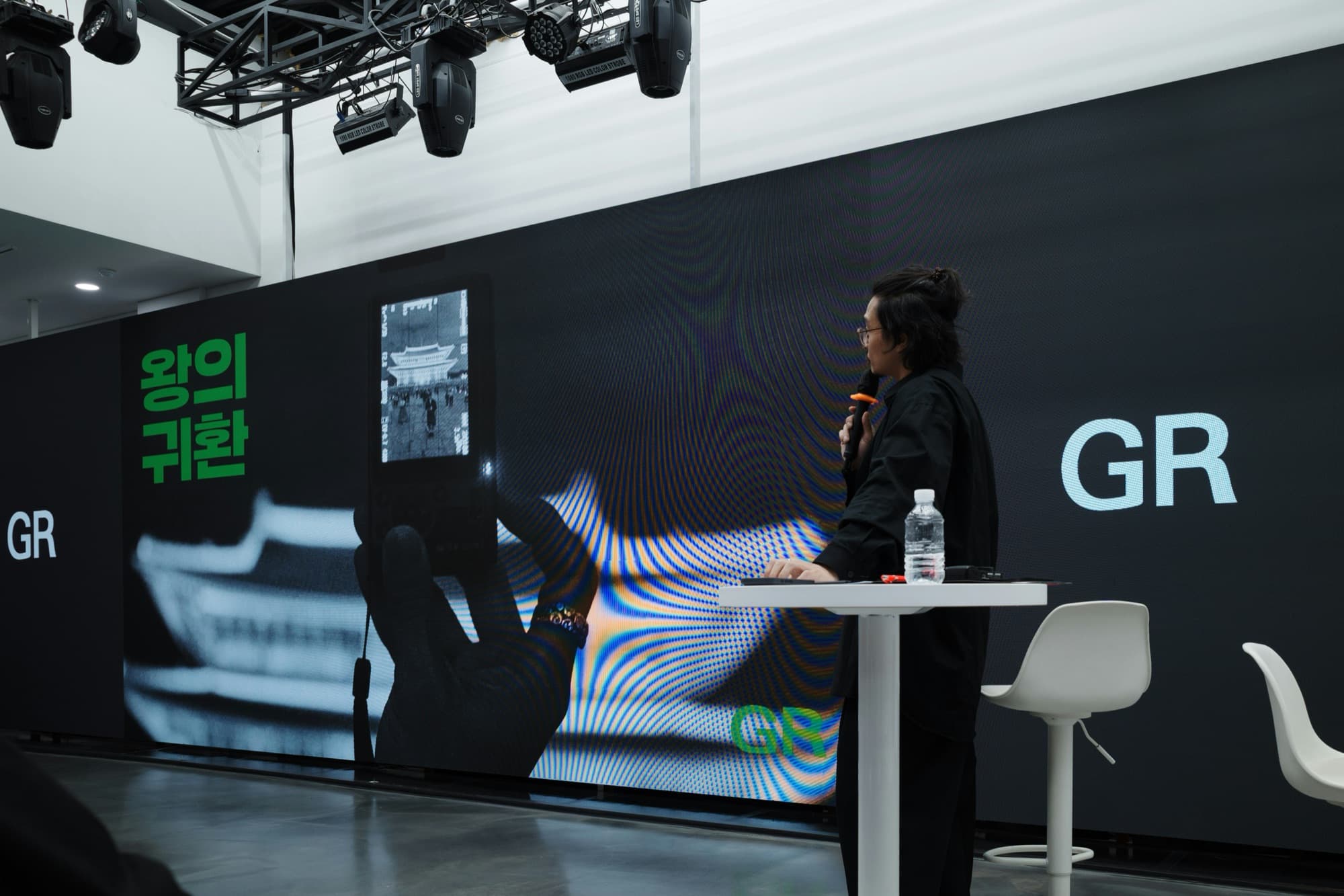Stage presentation in front of a screen wall